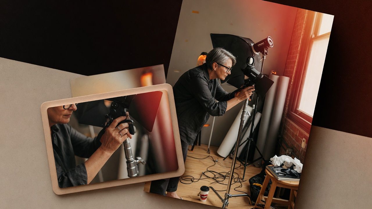 Photographer adjusting studio lighting equipment